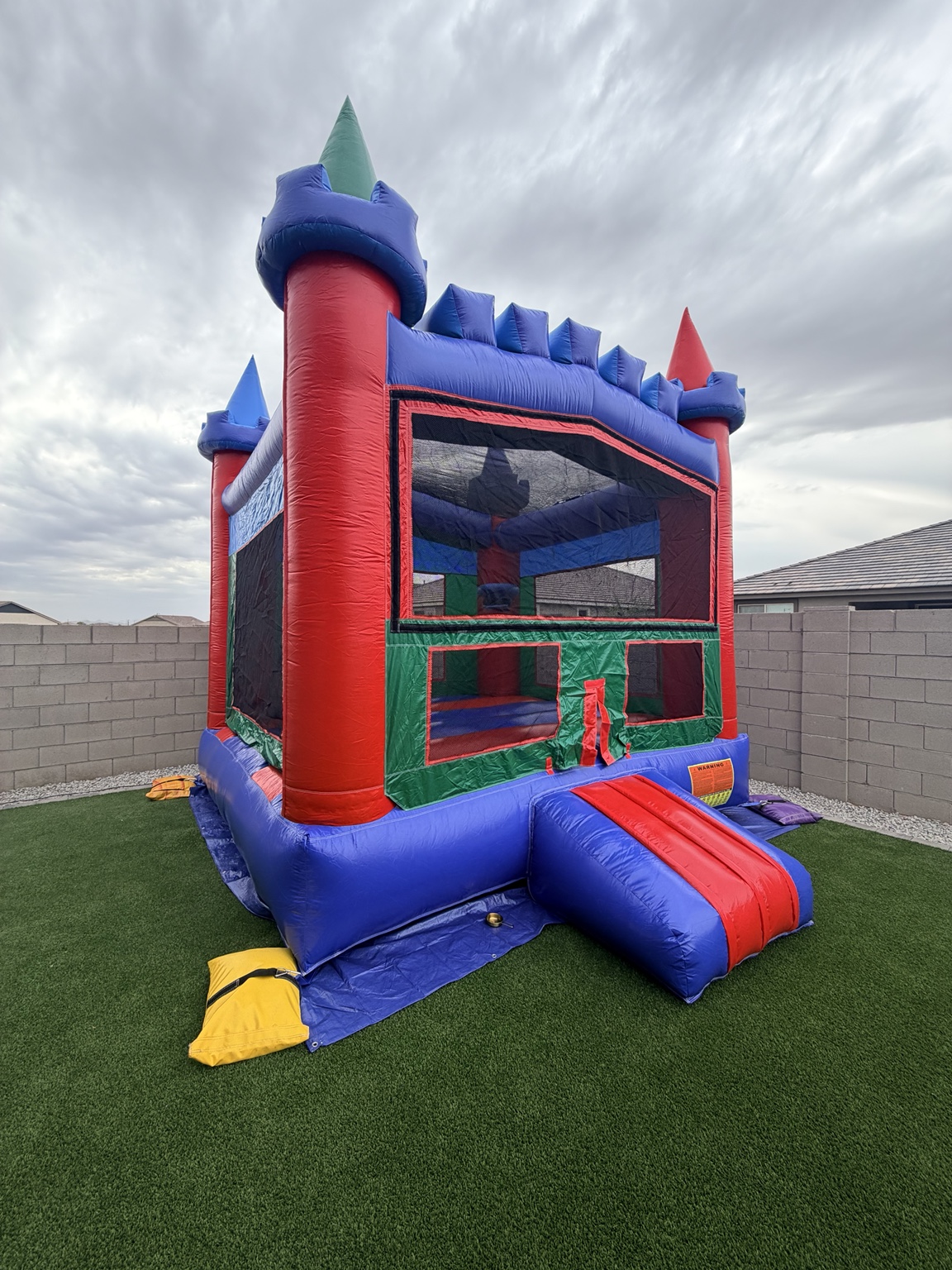 Our colorful 13 by 13 foot bounce house available to rent